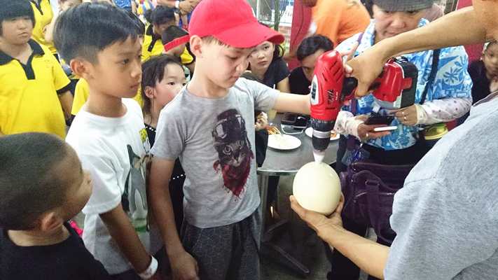 Children with the Ostrich Egg in PD Ostrich Show Farm